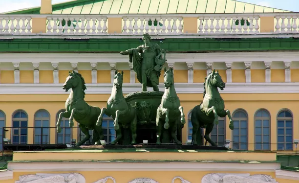 das gelbe Gebäude und die Statue mit den Pferden